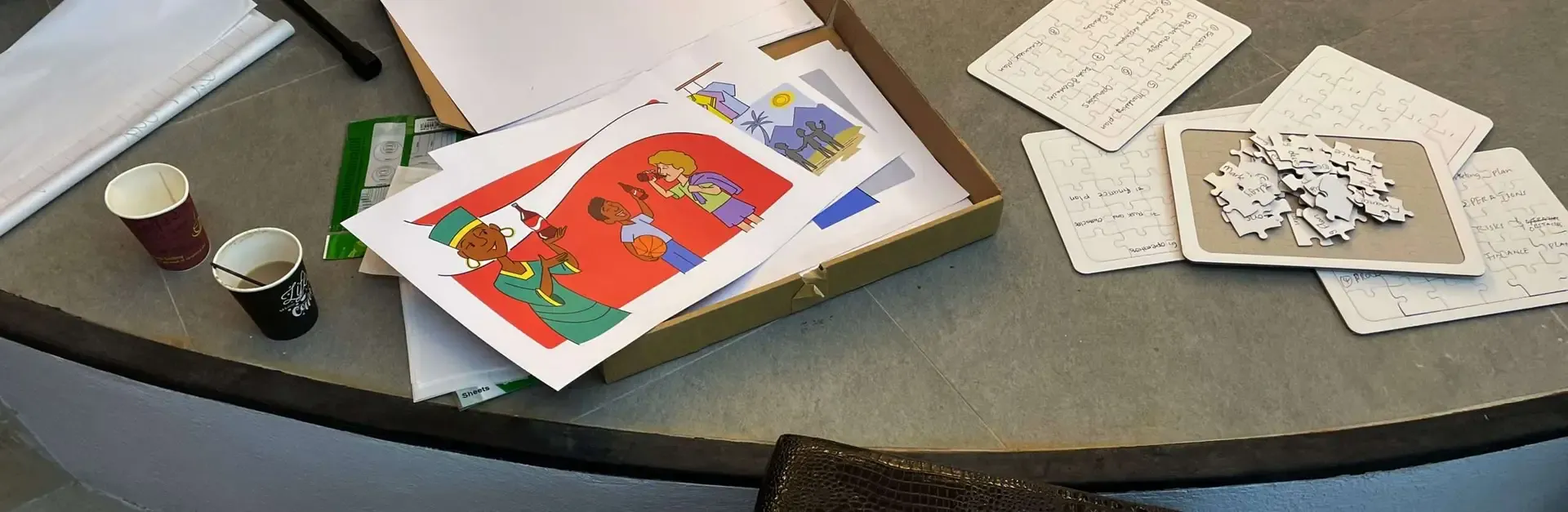 Illustrated story cards spread out in an open box on a table.
